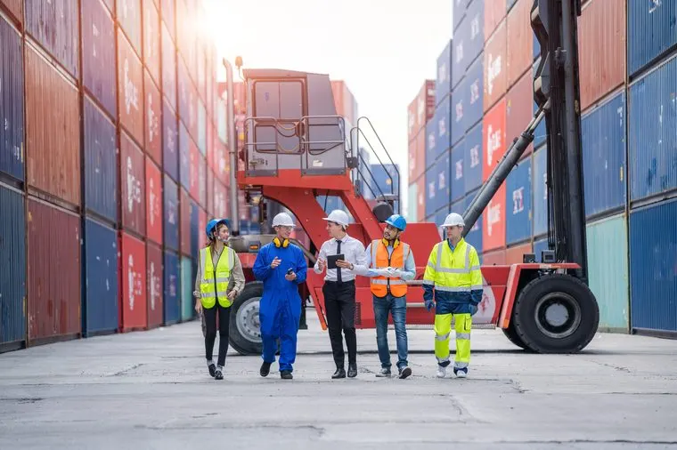 Logistics team walking a container yard